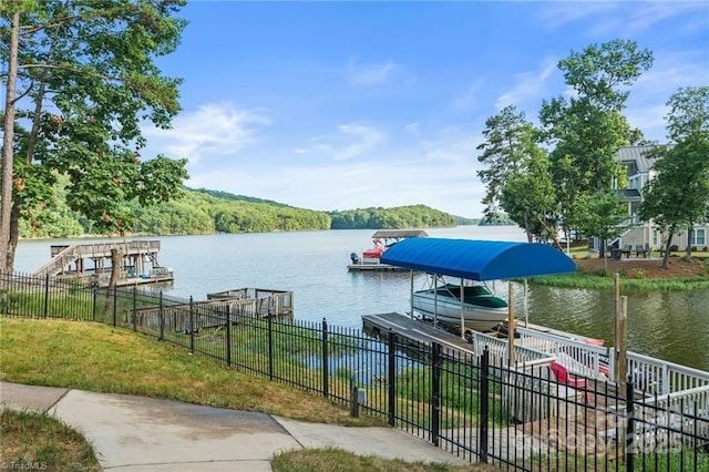 592 Shoreline Rd, New London, NC 28127 - dock area with a water view, boat lift, and a view of trees