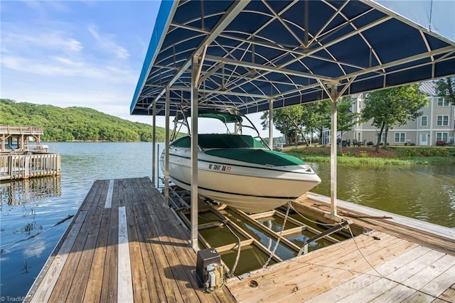 592 Shoreline Rd, New London, NC 28127 - dock featuring boat lift and a water view