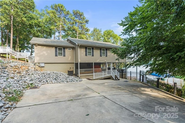 592 Shoreline Rd, New London, NC 28127 - view of front facade with fence, cooling unit, and covered porch
