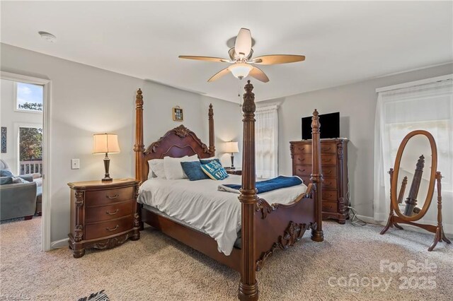 592 Shoreline Rd, New London, NC 28127 - bedroom with light carpet, ceiling fan, and baseboards
