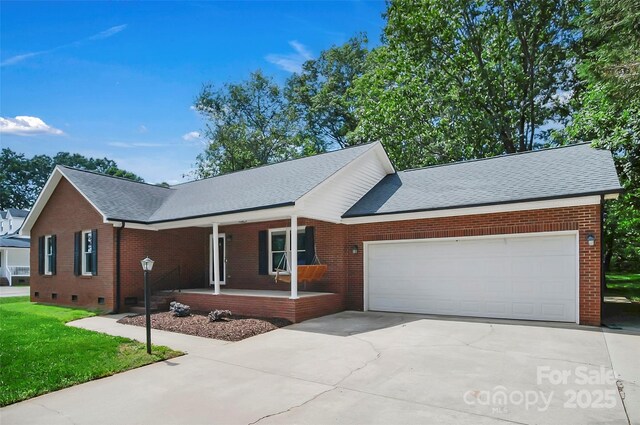 ranch-style home featuring a porch, an attached garage, driveway, brick siding, and roof with shingles