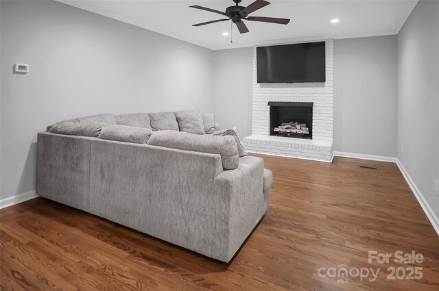 living room featuring ceiling fan, recessed lighting, baseboards, wood finished floors, and a fireplace