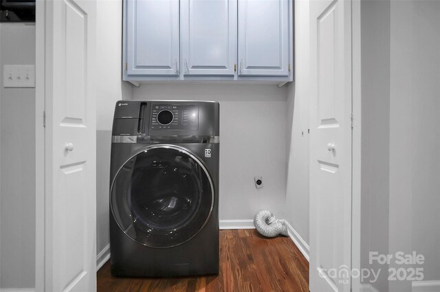 washroom with washer / dryer, cabinet space, dark wood-type flooring, and baseboards