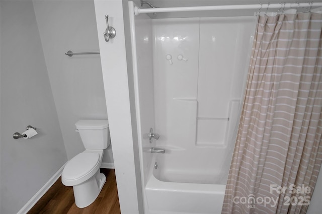 full bathroom featuring wood finished floors, toilet, shower / bath combo, and baseboards