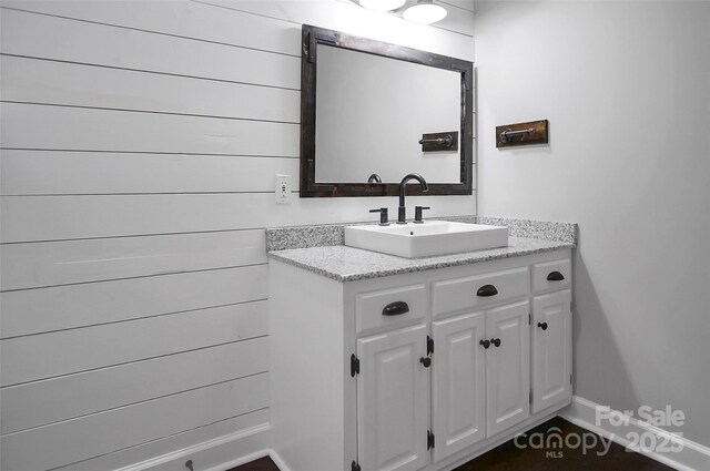 bathroom with baseboards and vanity