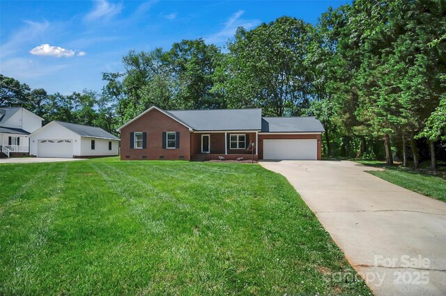 ranch-style home with crawl space, a garage, concrete driveway, and a front lawn