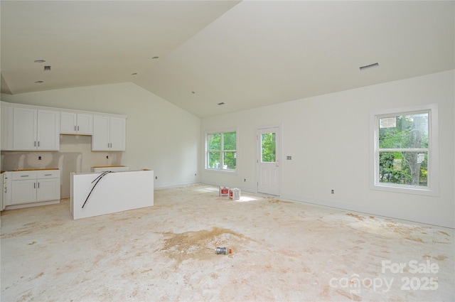 2706 Lyla Ave, Concord, NC 28027 - unfurnished living room featuring vaulted ceiling and light colored carpet