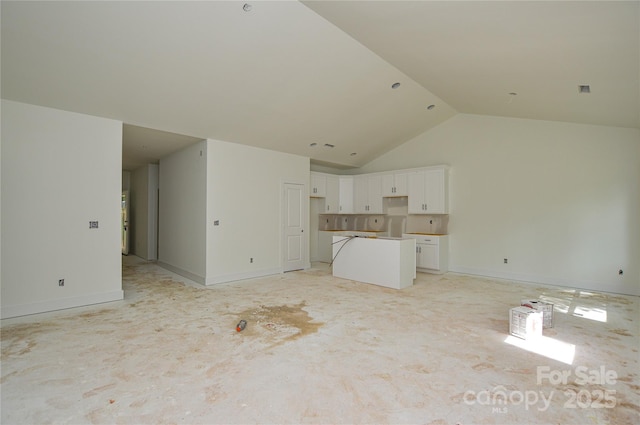 2706 Lyla Ave, Concord, NC 28027 - unfurnished living room featuring high vaulted ceiling and baseboards