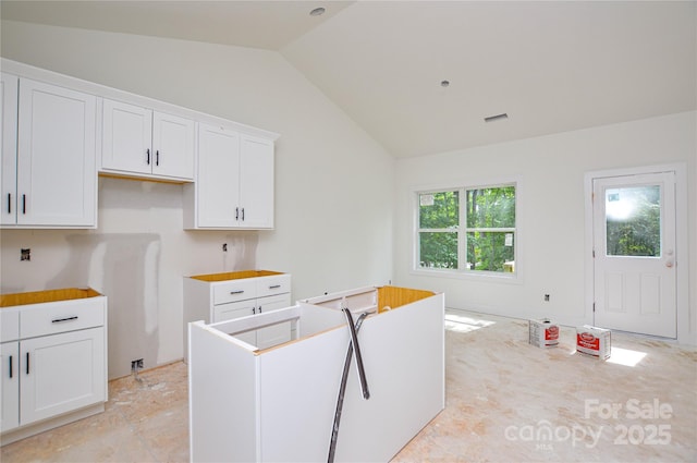 2706 Lyla Ave, Concord, NC 28027 - kitchen featuring vaulted ceiling and white cabinetry