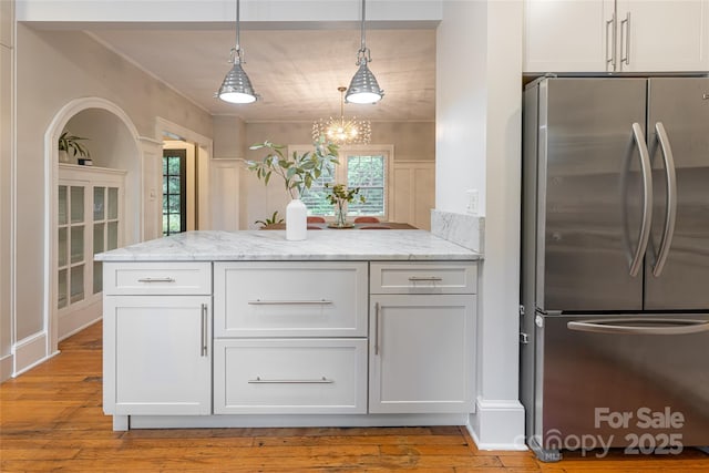 118 Macon Ave, Asheville, NC 28801 - kitchen with freestanding refrigerator, white cabinetry, a peninsula, light wood finished floors, and ornamental molding