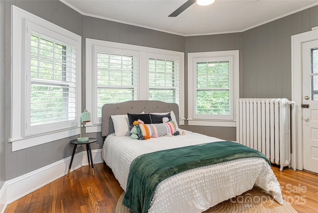 118 Macon Ave, Asheville, NC 28801 - bedroom with radiator heating unit, crown molding, wood finished floors, and ceiling fan
