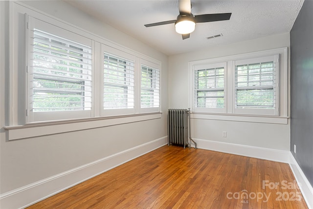 118 Macon Ave, Asheville, NC 28801 - spare room with radiator heating unit, wood finished floors, baseboards, and a ceiling fan
