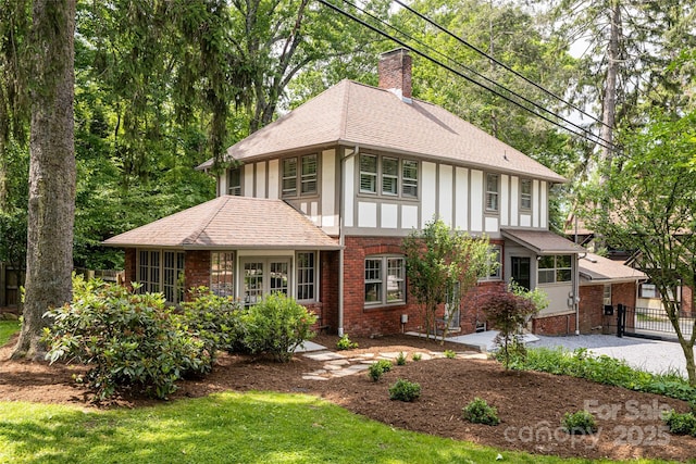 118 Macon Ave, Asheville, NC 28801 - english style home with a chimney, roof with shingles, board and batten siding, and brick siding