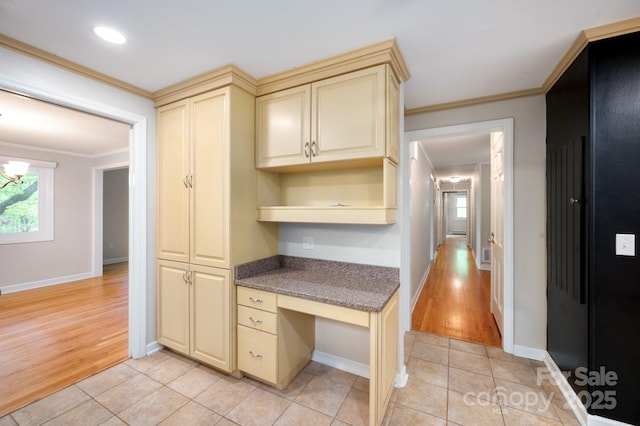 200 Allen Mountain Dr, Black Mountain, NC 28711 - kitchen with cream cabinetry, crown molding, baseboards, light wood-type flooring, and dark stone countertops