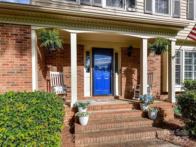 2315 Lawton Bluff Rd, Charlotte, NC 28226 - view of exterior entry featuring brick siding and a porch