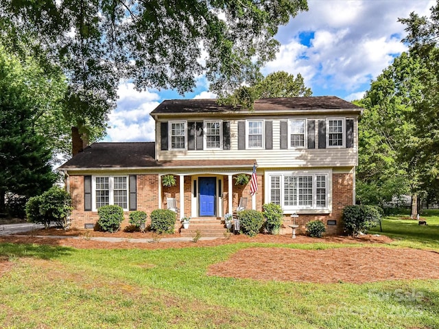 2315 Lawton Bluff Rd, Charlotte, NC 28226 - view of front facade featuring a front lawn, brick siding, a chimney, and crawl space