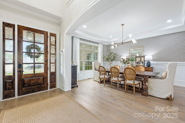 1445 Cherry Laurel Dr, Waxhaw, NC 28173 - entrance foyer featuring crown molding, wood finished floors, a chandelier, a wainscoted wall, and wallpapered walls