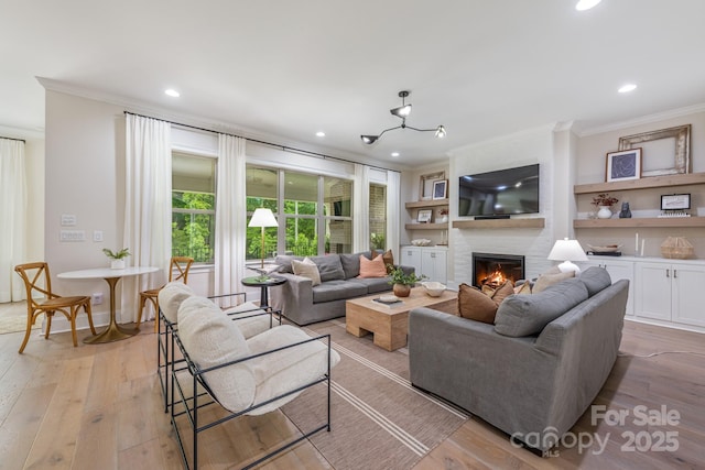 1445 Cherry Laurel Dr, Waxhaw, NC 28173 - living room with crown molding, a large fireplace, light wood-type flooring, and recessed lighting