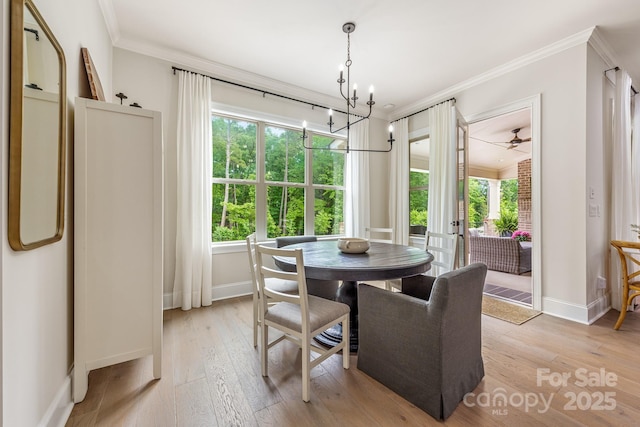 1445 Cherry Laurel Dr, Waxhaw, NC 28173 - dining area featuring ornamental molding, baseboards, light wood finished floors, and a chandelier