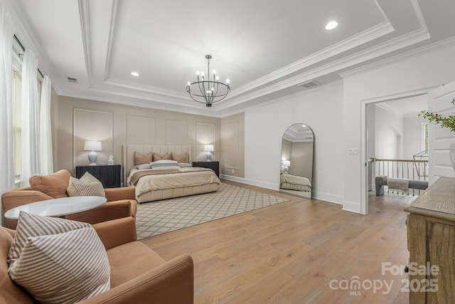 1445 Cherry Laurel Dr, Waxhaw, NC 28173 - bedroom with ornamental molding, light wood-type flooring, a chandelier, a tray ceiling, and baseboards