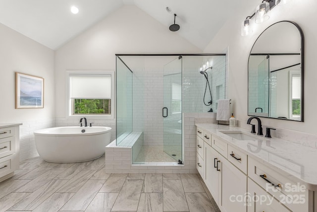 1445 Cherry Laurel Dr, Waxhaw, NC 28173 - full bathroom with a shower stall, vanity, a freestanding bath, a wainscoted wall, and tile walls