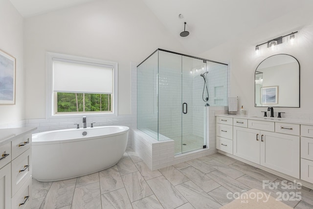 1445 Cherry Laurel Dr, Waxhaw, NC 28173 - full bathroom with a shower stall, vanity, vaulted ceiling, a soaking tub, and marble look tiles