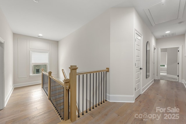1445 Cherry Laurel Dr, Waxhaw, NC 28173 - hallway with an upstairs landing, attic access, light wood-type flooring, baseboards, and recessed lighting
