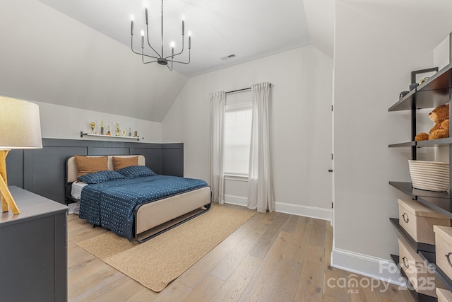 1445 Cherry Laurel Dr, Waxhaw, NC 28173 - bedroom featuring a chandelier, light wood-style floors, baseboards, and vaulted ceiling
