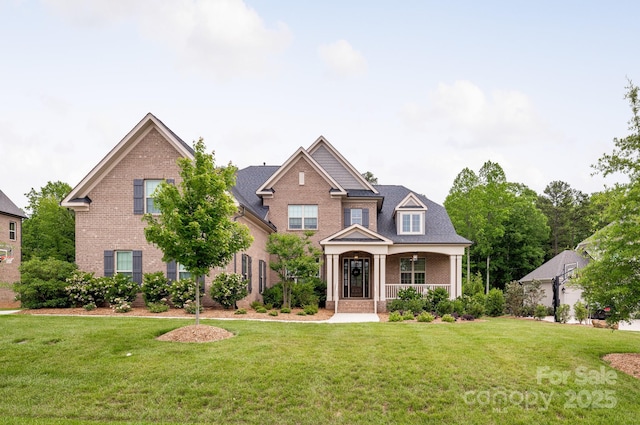 1445 Cherry Laurel Dr, Waxhaw, NC 28173 - view of front of home featuring brick siding, covered porch, and a front lawn