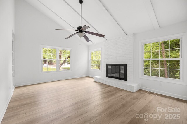 6713 William Harry Ct, Charlotte, NC 28211 - unfurnished living room with ceiling fan, beamed ceiling, baseboards, a fireplace, and light wood-style floors