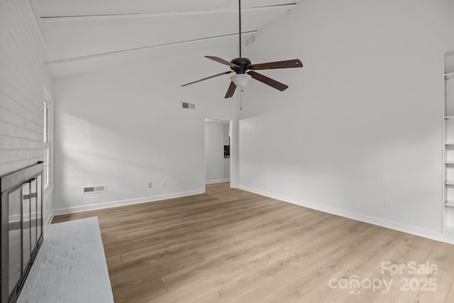 6713 William Harry Ct, Charlotte, NC 28211 - unfurnished living room with ceiling fan, high vaulted ceiling, wood finished floors, and baseboards