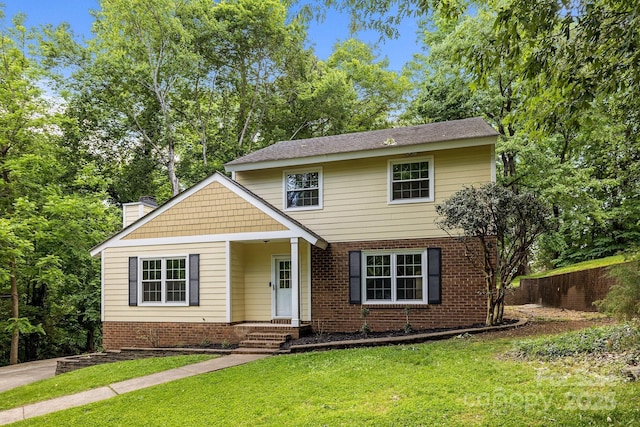 6713 William Harry Ct, Charlotte, NC 28211 - traditional-style house with brick siding, a chimney, and a front lawn