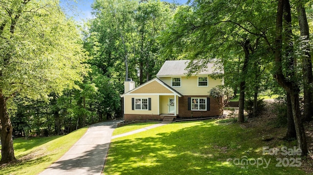 6713 William Harry Ct, Charlotte, NC 28211 - view of front of home with a chimney, a front lawn, driveway, and brick siding
