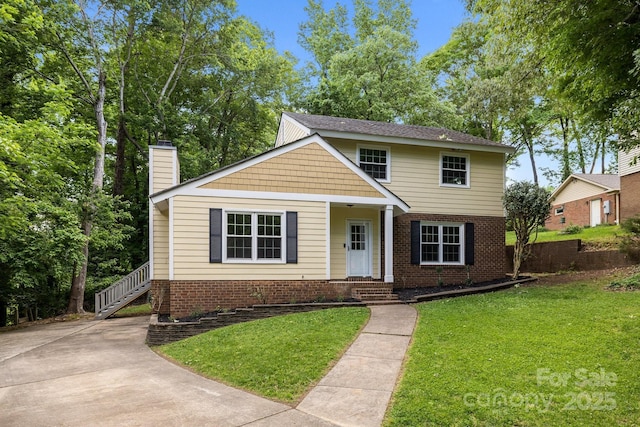 6713 William Harry Ct, Charlotte, NC 28211 - traditional-style home with a front yard, a chimney, and brick siding