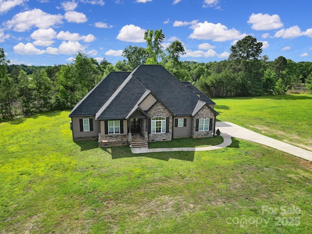 1166 Rocky River Rd, Lancaster, SC 29720 - view of front of property with a front lawn, stone siding, a wooded view, and a shingled roof