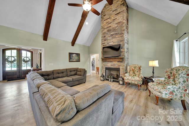 1166 Rocky River Rd, Lancaster, SC 29720 - living room featuring high vaulted ceiling, wood finished floors, beam ceiling, ceiling fan, and a stone fireplace
