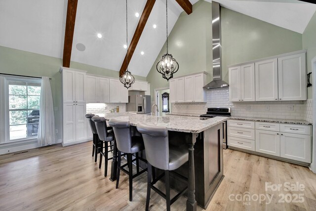 1166 Rocky River Rd, Lancaster, SC 29720 - kitchen featuring stainless steel appliances, high vaulted ceiling, a kitchen island with sink, beamed ceiling, and white cabinets