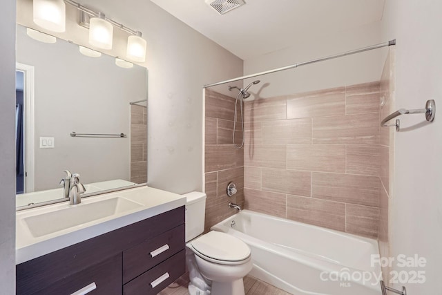 bathroom featuring toilet, bathtub / shower combination, and vanity
