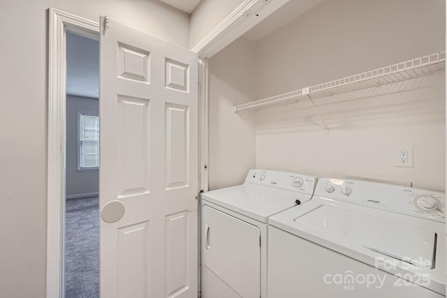 laundry room featuring washing machine and clothes dryer and carpet