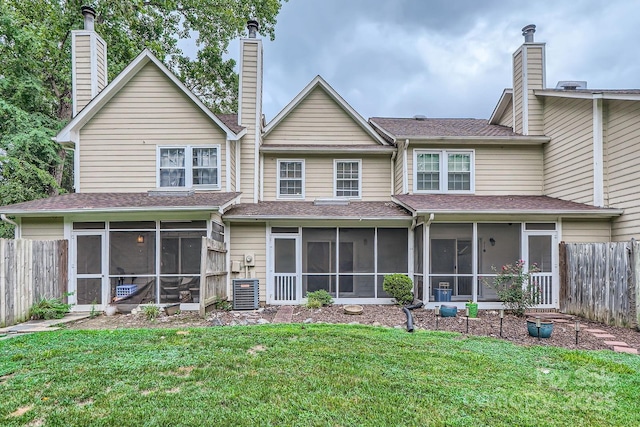 back of property with a sunroom, a chimney, and central AC unit
