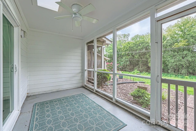 unfurnished sunroom featuring a ceiling fan
