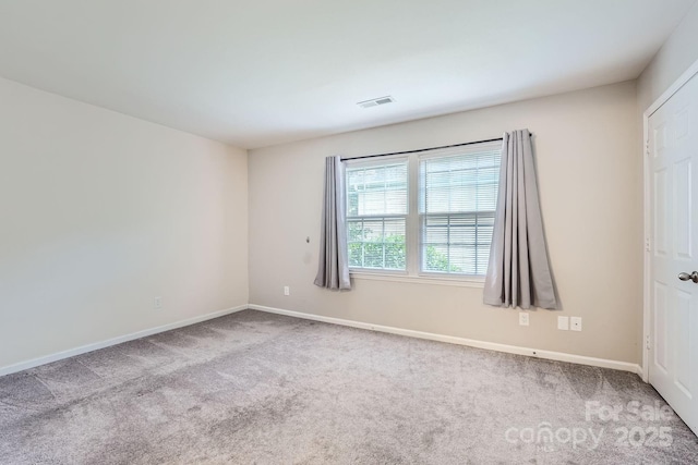 empty room with carpet flooring and baseboards