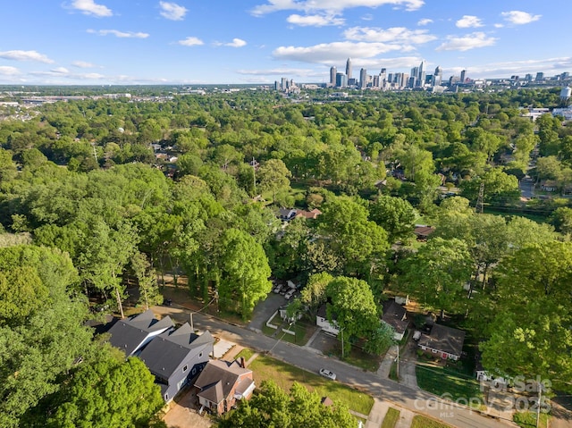2006 St John St, Charlotte, NC 28216 - aerial view of property and surrounding area featuring city skyline and a heavily wooded area