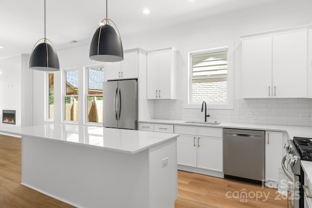 2006 St John St, Charlotte, NC 28216 - kitchen with stainless steel appliances, healthy amount of natural light, light countertops, decorative backsplash, and recessed lighting