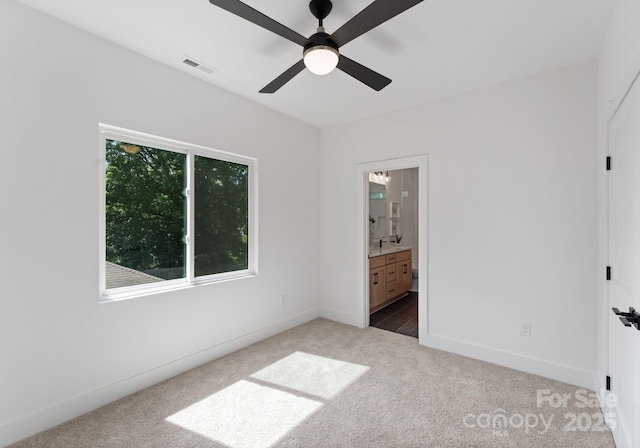 2006 St John St, Charlotte, NC 28216 - unfurnished bedroom with carpet floors, ensuite bathroom, and a ceiling fan