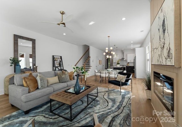 2006 St John St, Charlotte, NC 28216 - living area with stairway, light wood finished floors, a ceiling fan, recessed lighting, and a chandelier