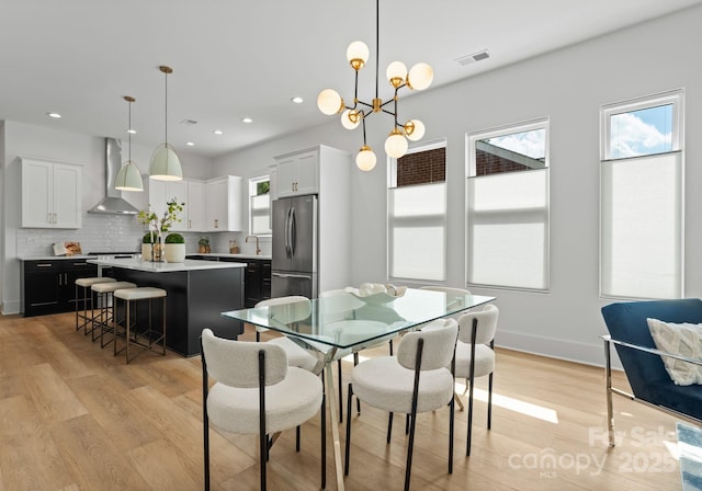 2006 St John St, Charlotte, NC 28216 - dining space featuring light wood finished floors, recessed lighting, and a chandelier