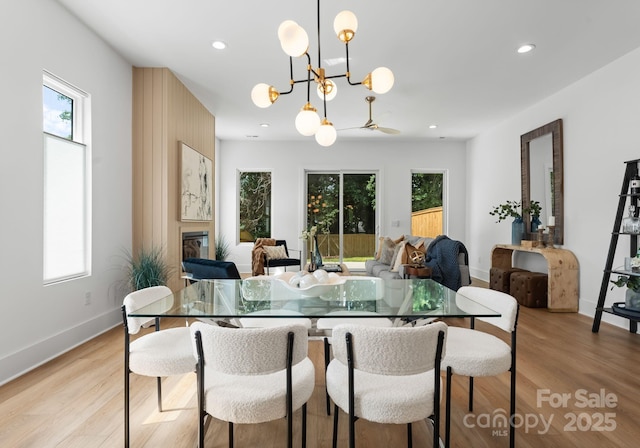 2006 St John St, Charlotte, NC 28216 - dining space featuring healthy amount of natural light, light wood-style flooring, recessed lighting, a chandelier, and a glass covered fireplace