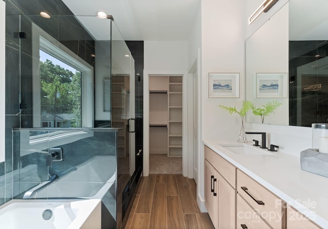 2006 St John St, Charlotte, NC 28216 - bathroom featuring vanity, wood finish floors, a shower stall, and a bath