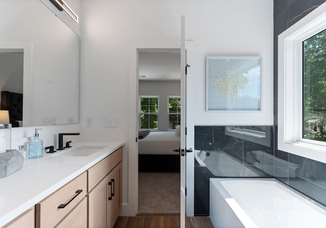 2006 St John St, Charlotte, NC 28216 - ensuite bathroom with a tub to relax in, vanity, and wood finished floors